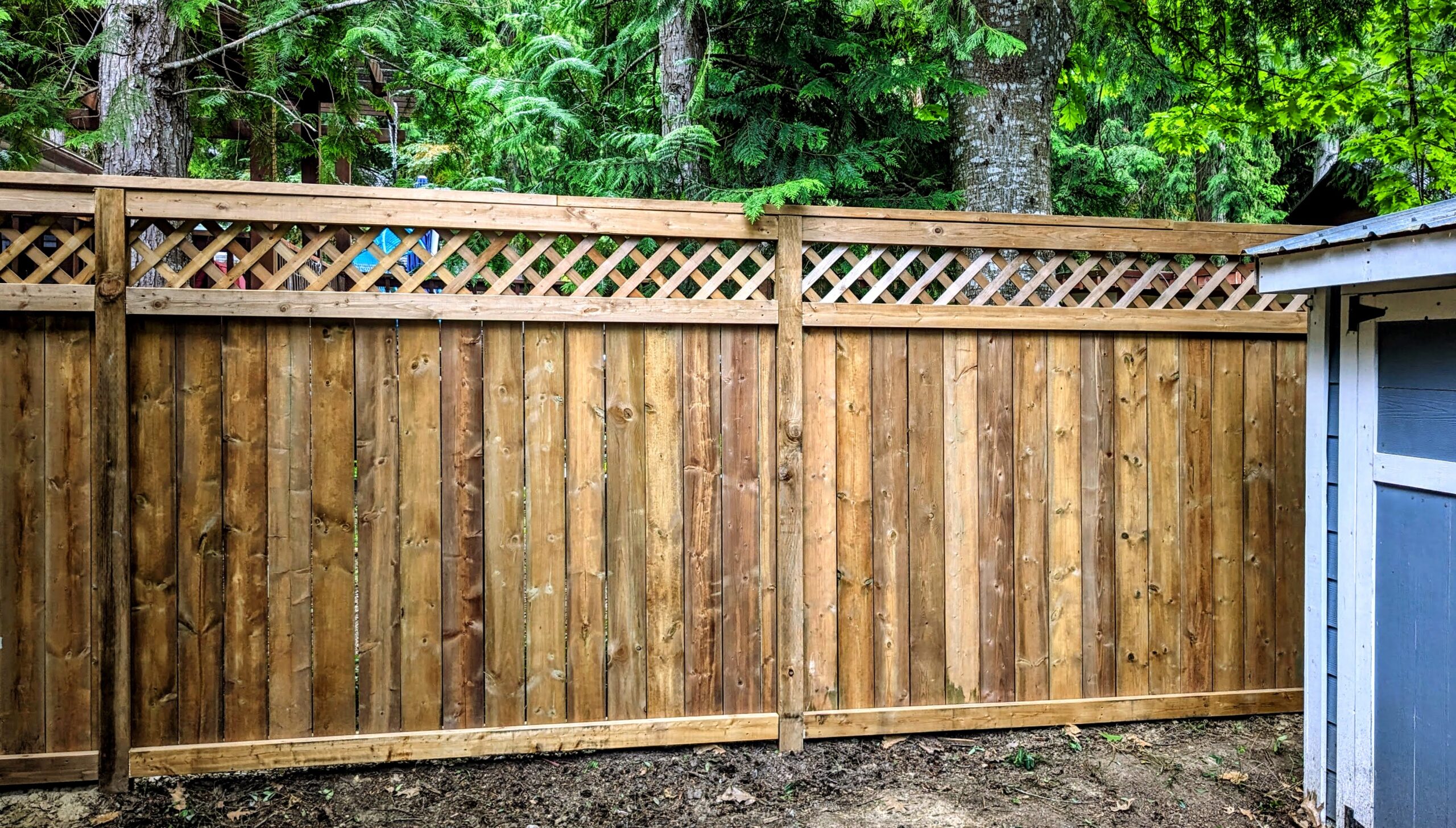 Image of wooden fence topped with lattice built by Perry Landscape Construction